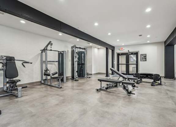 A spacious gym with various exercise equipment.