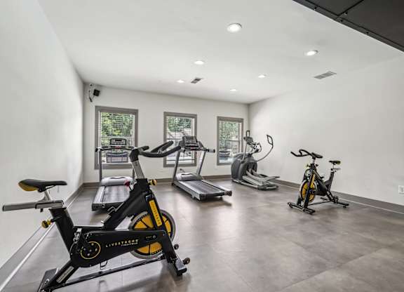 Exercise bikes is in a spacious room with treadmills