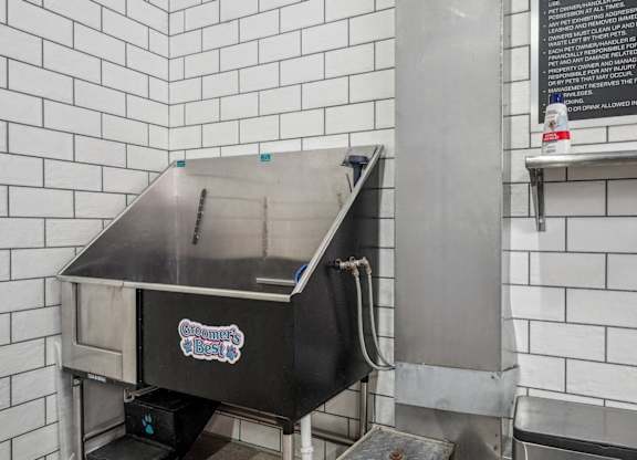 An enclosed stainless steel bathing tub for dogs or pets. Petspa