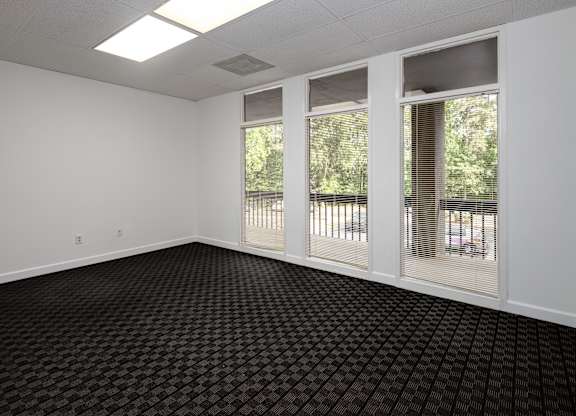 A room with black carpet and white walls.