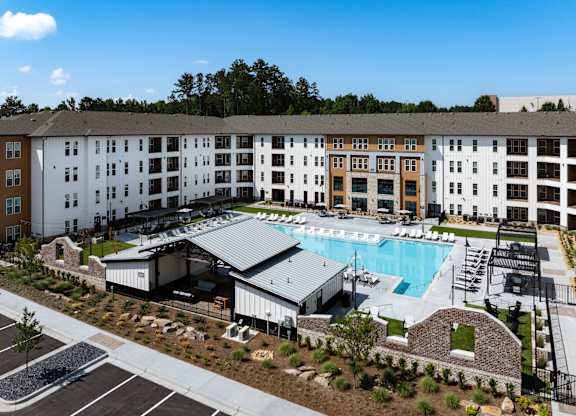 A large building with a pool in front of it.