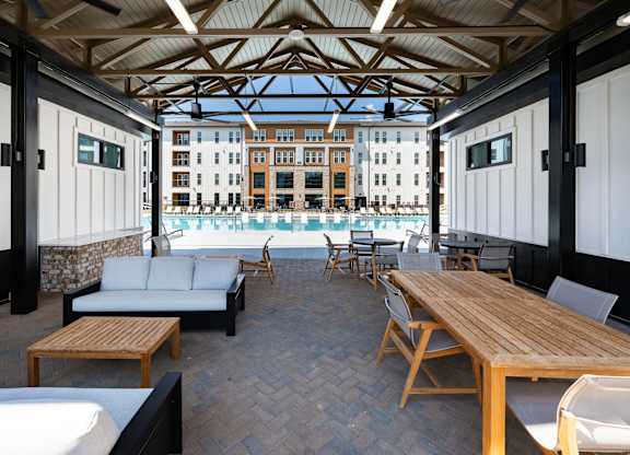 A wooden table and chairs are set up on a patio.