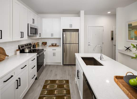 a kitchen with tons of counterspace and storage. with a farm style sink