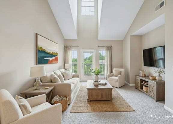 A living room with a large painting on the wall and a flat screen TV mounted above the entertainment center.