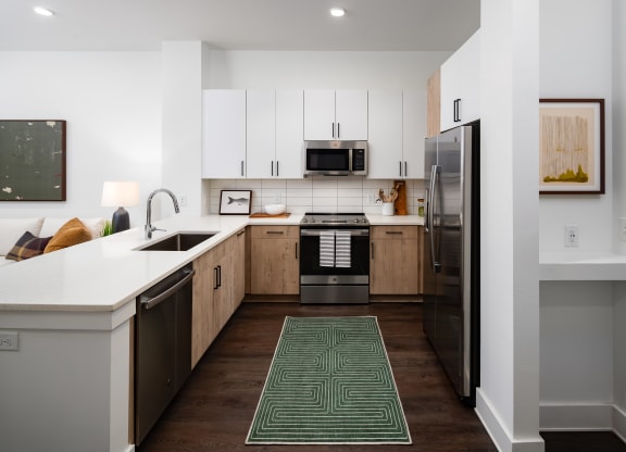 a kitchen with white cabinets and stainless steel appliances