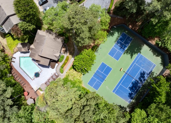 arial view of a house with a tennis court and a pool