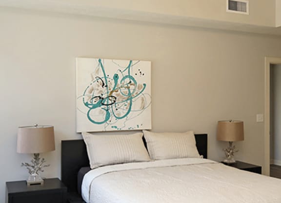 a bedroom with a bed and a large window