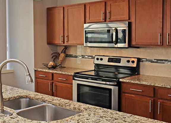 a kitchen with granite counter tops and stainless steel appliances