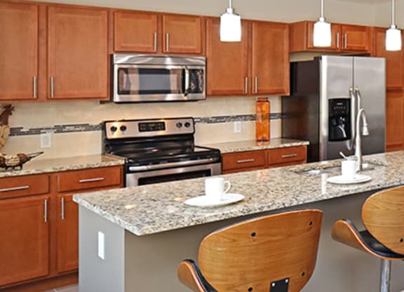 a kitchen and living room with a table and chairs