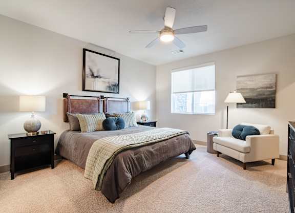 an empty bedroom with a bed and a ceiling fan at Parkside at Littleton Village, Littleton, Colorado