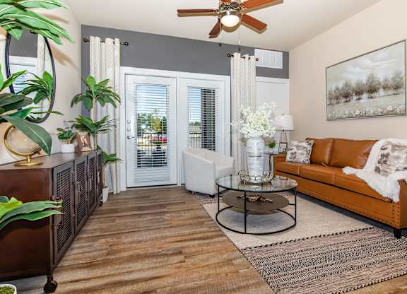 A living room with a brown leather couch and a coffee table.