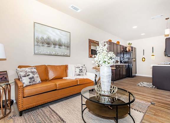 A living room with a brown couch and a coffee table.