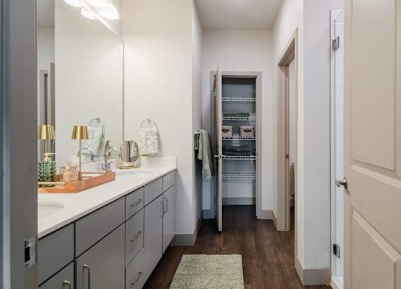 a bathroom with a sink and a mirror and a closet at Parkside at Littleton Village, Littleton, CO