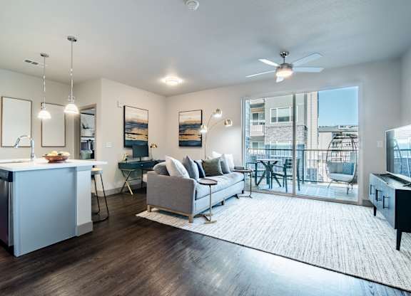a living room with a couch and a kitchen at Parkside at Littleton Village, Littleton, CO