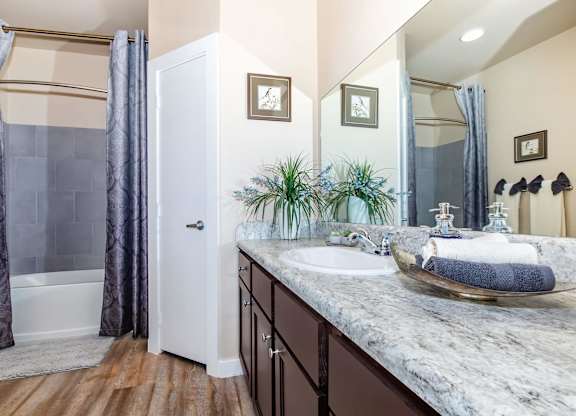 A bathroom with a marble countertop and a white door.