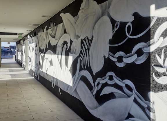 A long hallway with a black and white mural on the wall.