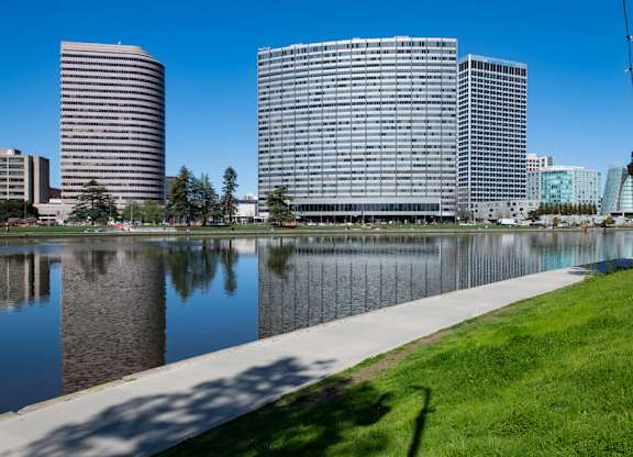 A cityscape with buildings and a body of water in the foreground.