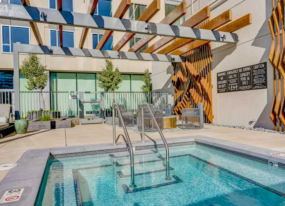 A pool with a slide and a sign that says