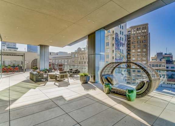 A modern outdoor seating area with a large sculpture in the middle.