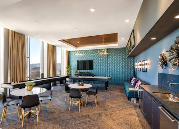 A modern kitchen and dining area with a view of the city.