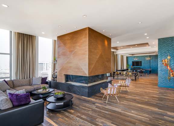 A modern living room with a wooden floor and a large wooden wall unit.