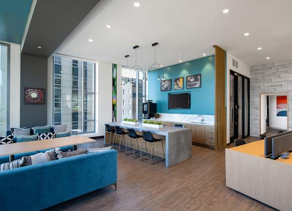 A modern living room with a blue couch and a wooden floor.