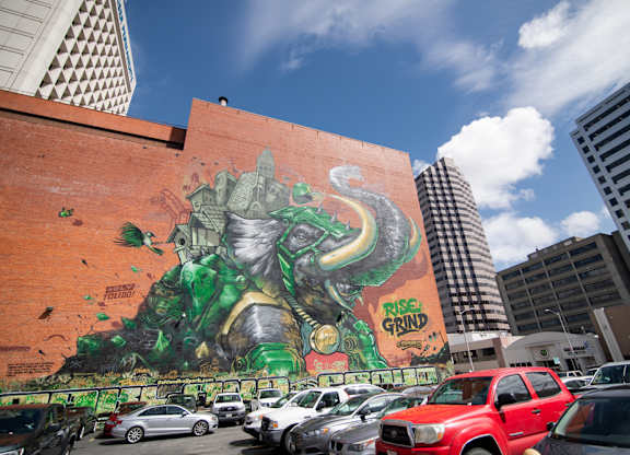 A large mural of a green monster on the side of a building.