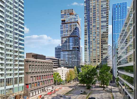 A cityscape with tall buildings and a clear sky.