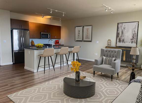 Open concept living room and kitchen area at Axis Seattle Apartments, Washington