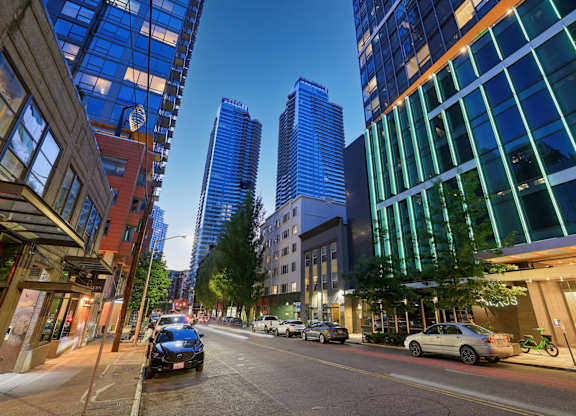 A city street with cars and tall buildings.