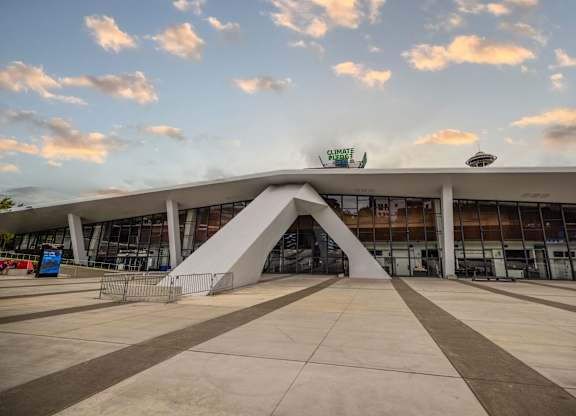 Modern arena with curved architectural entrance at Axis Seattle Apartments, Seattle, WA 98109
