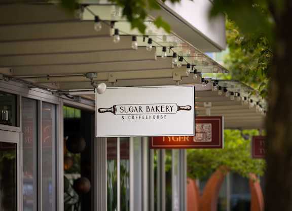 Sugar bakery and coffeehouse storefront sign at Axis Seattle Apartments, Seattle