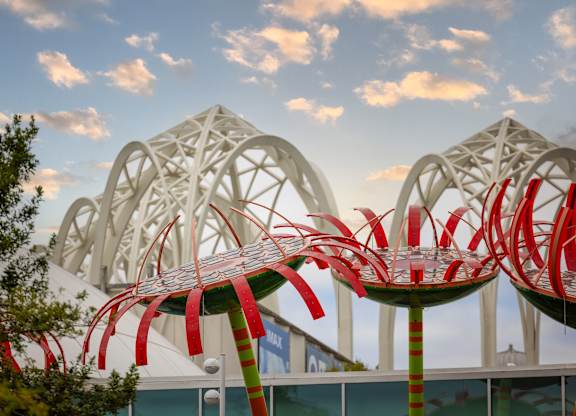 Decorative palm tree sculptures with white arch structures at Axis Seattle Apartments, Seattle