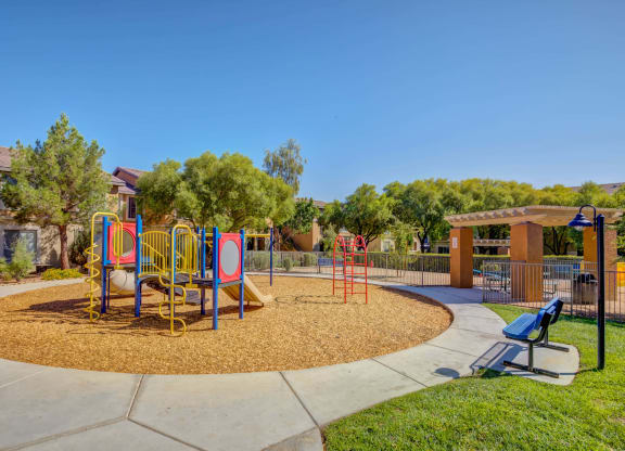 Spring Valley, NV, 89147 Apartments for Rent - Alicante - Playground with a Slide, Monkey Bars, and a Park Bench