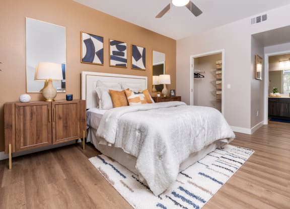 a bedroom with a bed and a ceiling fan