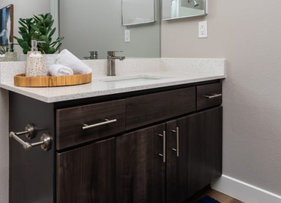 the retreat apartments renovated bathroom with counter top and mirror