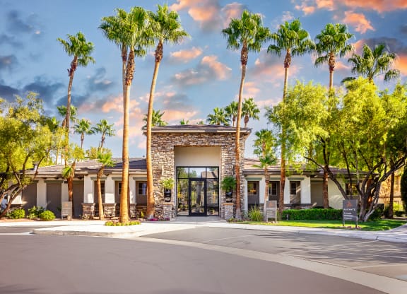 89147 Apartments for Rent Spring Valley NV - Alicante - Leasing Office Exterior Surrounded by Palm Tree and Landscaped Ground, Available Parking in Front