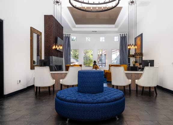 a living room with a blue chair and a table with chairs