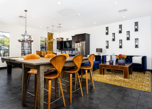 a dining area with a table and chairs and a living room with a television