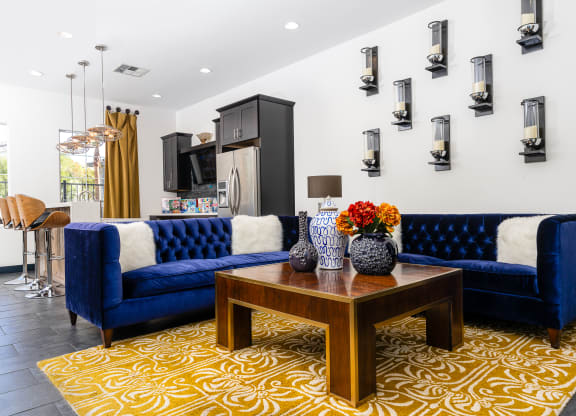a living room with blue couches and a table