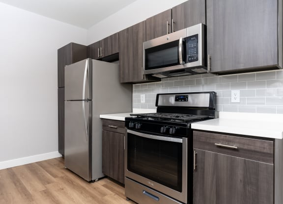 a kitchen with stainless steel appliances and a refrigerator
