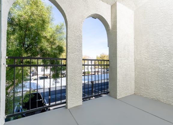 a balcony with a view of a pool and trees