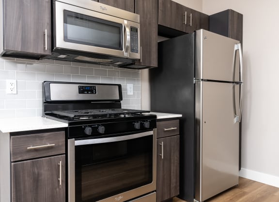 a kitchen with stainless steel appliances and a refrigerator