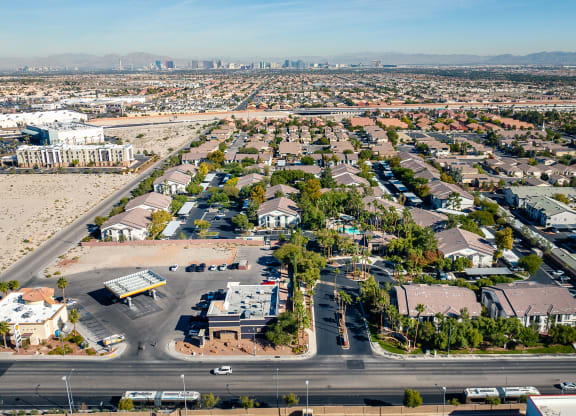 an aerial view of a neighborhood of houses and cars on a road
