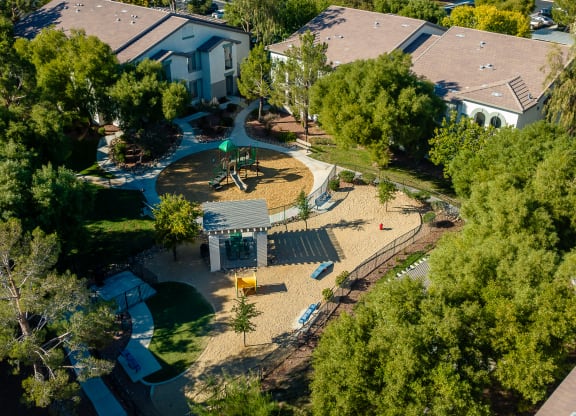 an aerial view of a playground in a neighborhood with houses