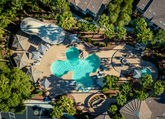 an aerial view of a swimming pool with blue water