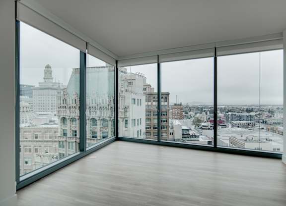 A large empty room with a view of the city.
