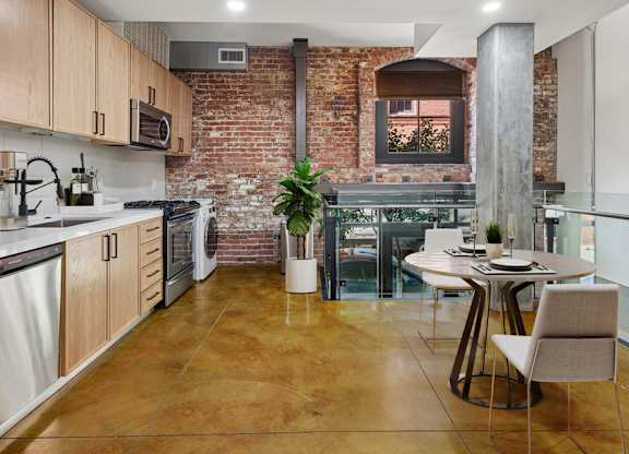 A kitchen with a table and chairs in the middle of the room.