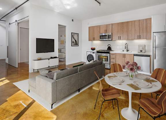 A modern kitchen with a dining table set for four.