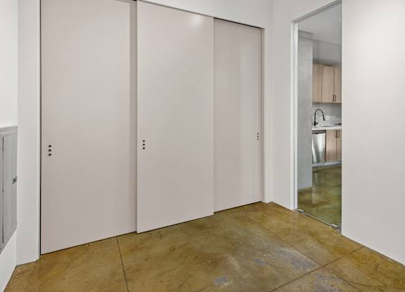 Three white doors in a room.
